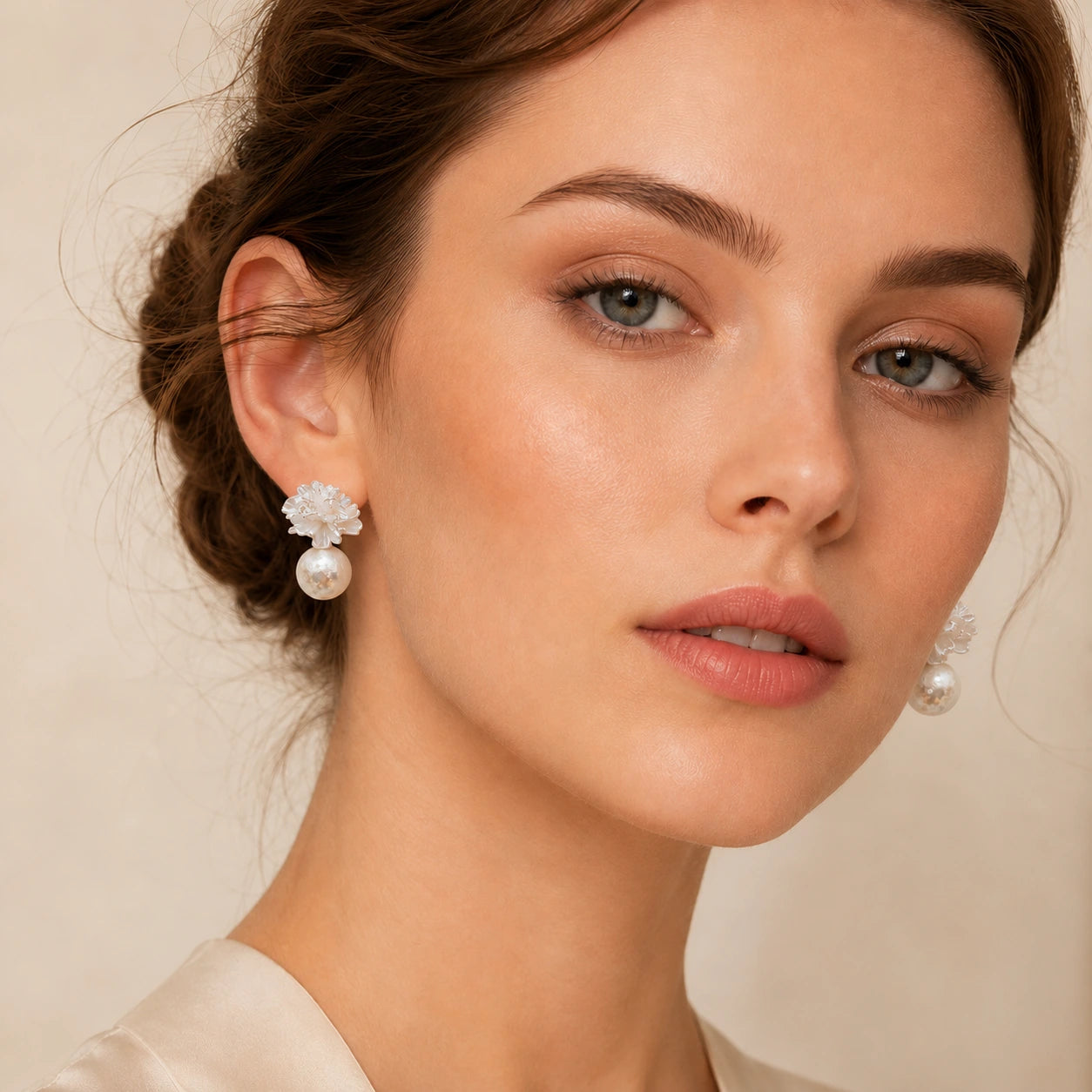 Model wearing white flower pearl earrings with an elegant swept-back hairstyle.
