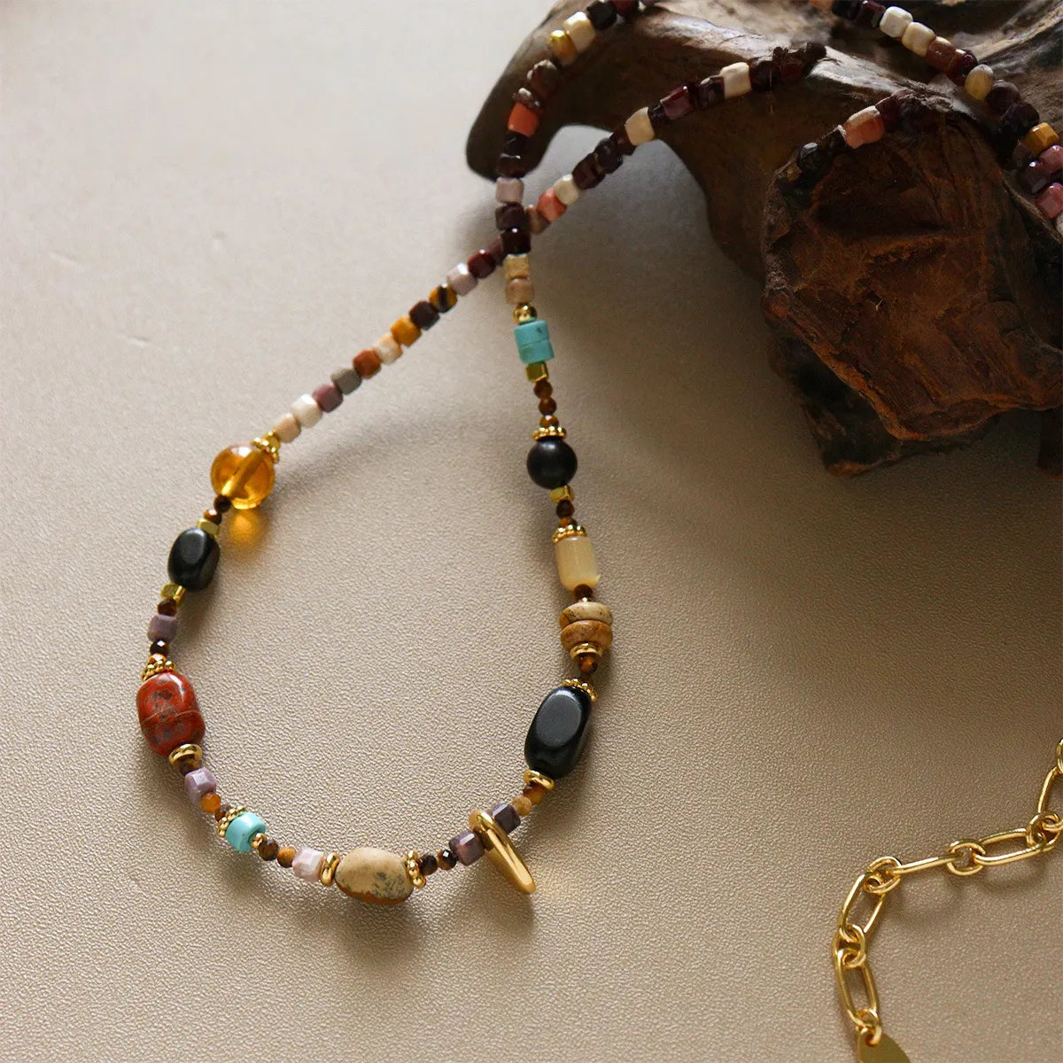 Colorful bead necklace with obsidian, picture stone, glass beads and gold-tone clasp detail