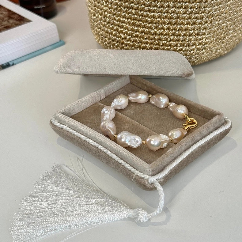 Baroque pearl statement bracelet with a gold clasp presented in an elegant jewelry gift box