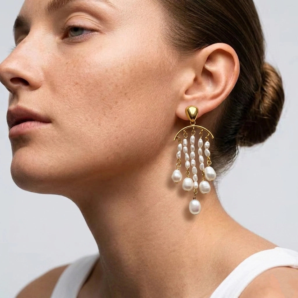 Model wearing gold-plated pearl chandelier earrings with an elegant updo