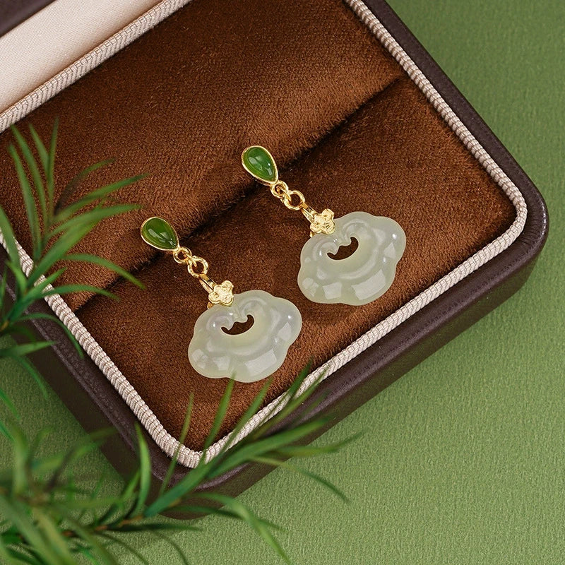 Hetian jade ruyi lock drop earrings in S925 silver displayed in a brown jewelry box.