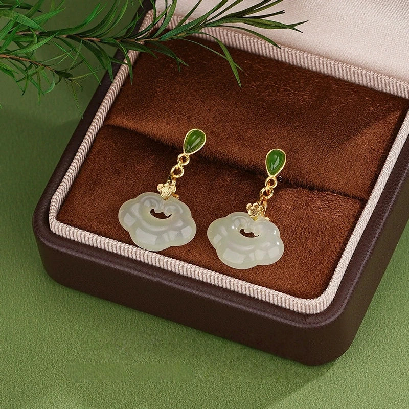 Elegant white jade drop earrings in S925 silver shown in open jewelry box with botanical styling.