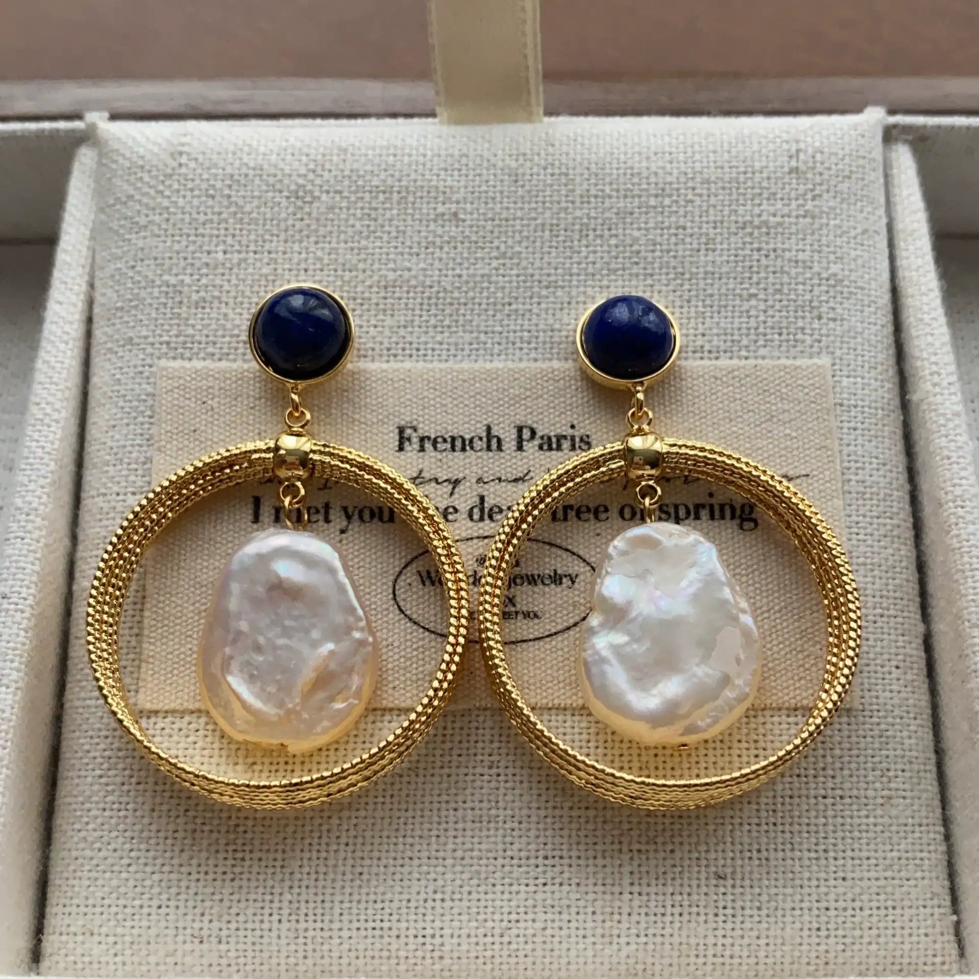 Gold hoop earrings with deep blue lapis lazuli studs and irregular baroque pearls