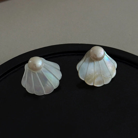 Natural mother-of-pearl seashell stud earrings with iridescent white shell and pearl accents.