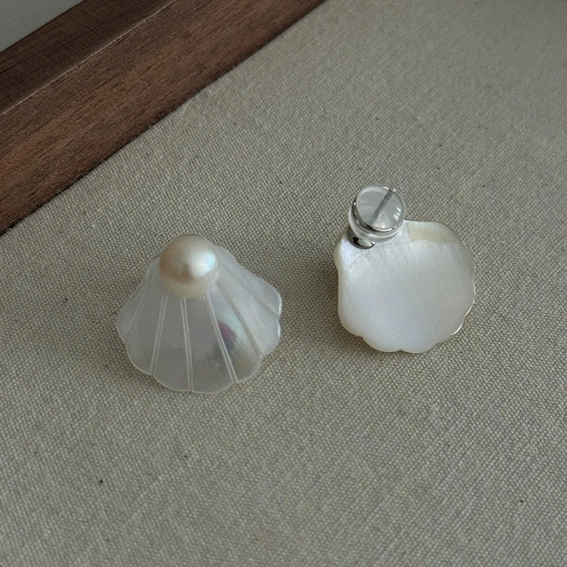 Front and back view of natural shell stud earrings showing the silver-tone post fastening.