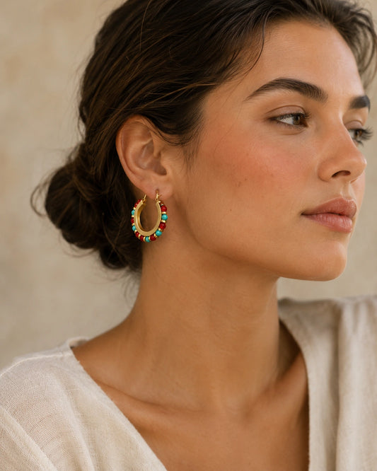 Model wearing natural stone boho hoop earrings with colorful beads and gold tone copper