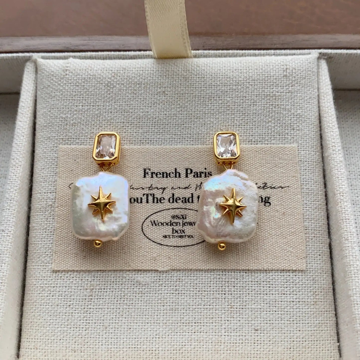 Square baroque pearl drop earrings featuring crystal studs and celestial starburst accents
