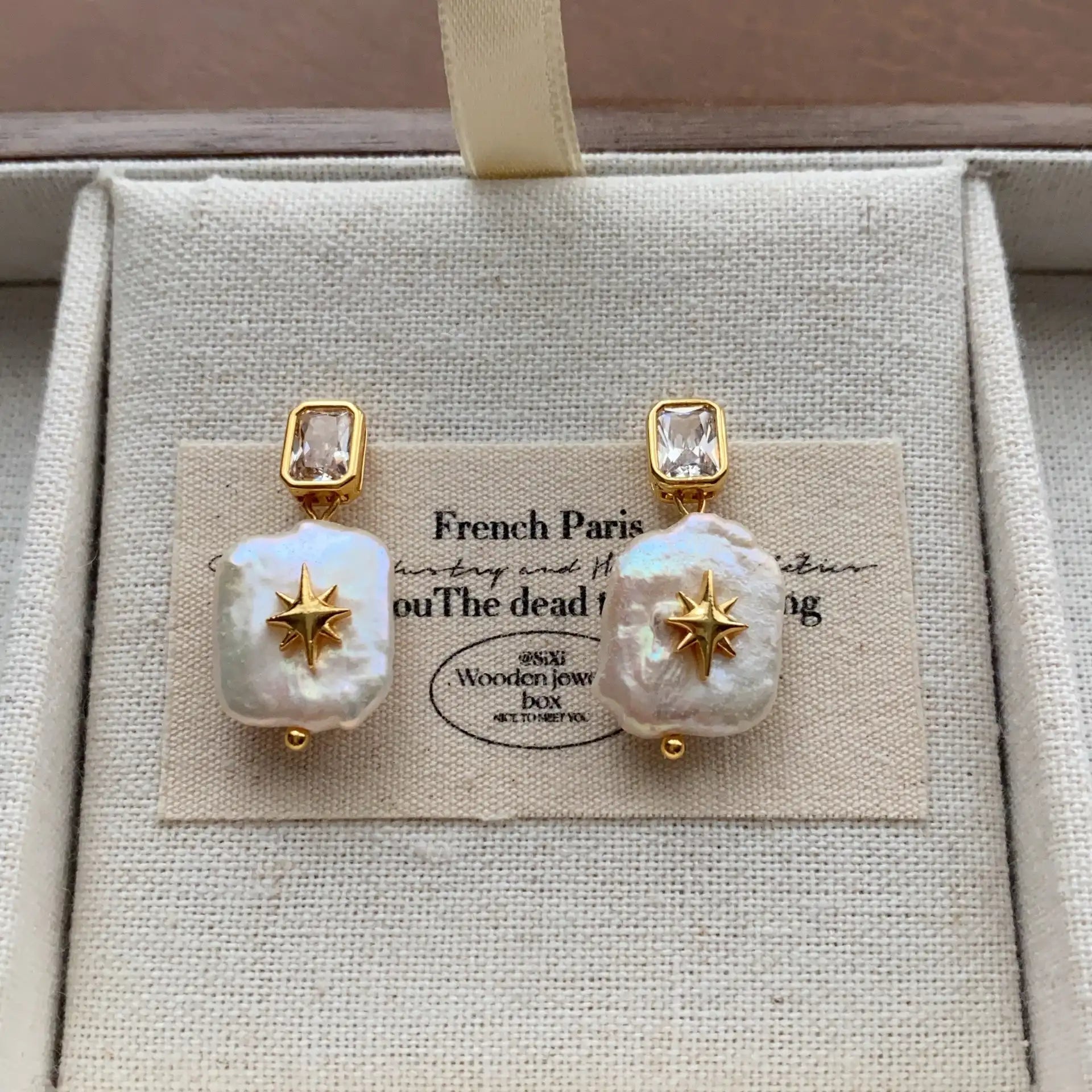 Square baroque pearl drop earrings featuring crystal studs and celestial starburst accents