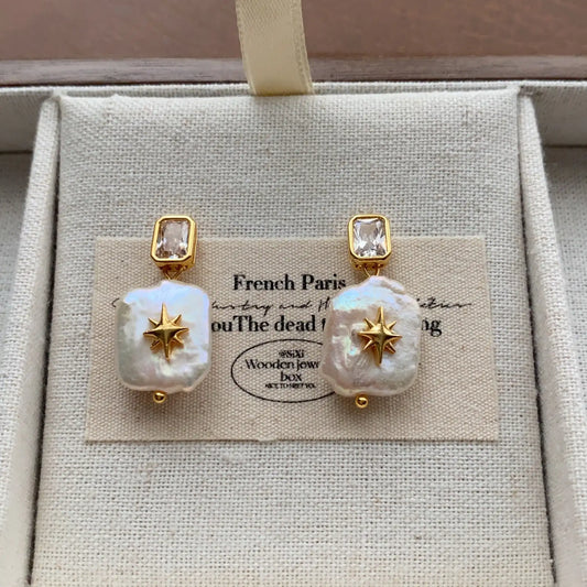 Square baroque pearl drop earrings featuring crystal studs and celestial starburst accents