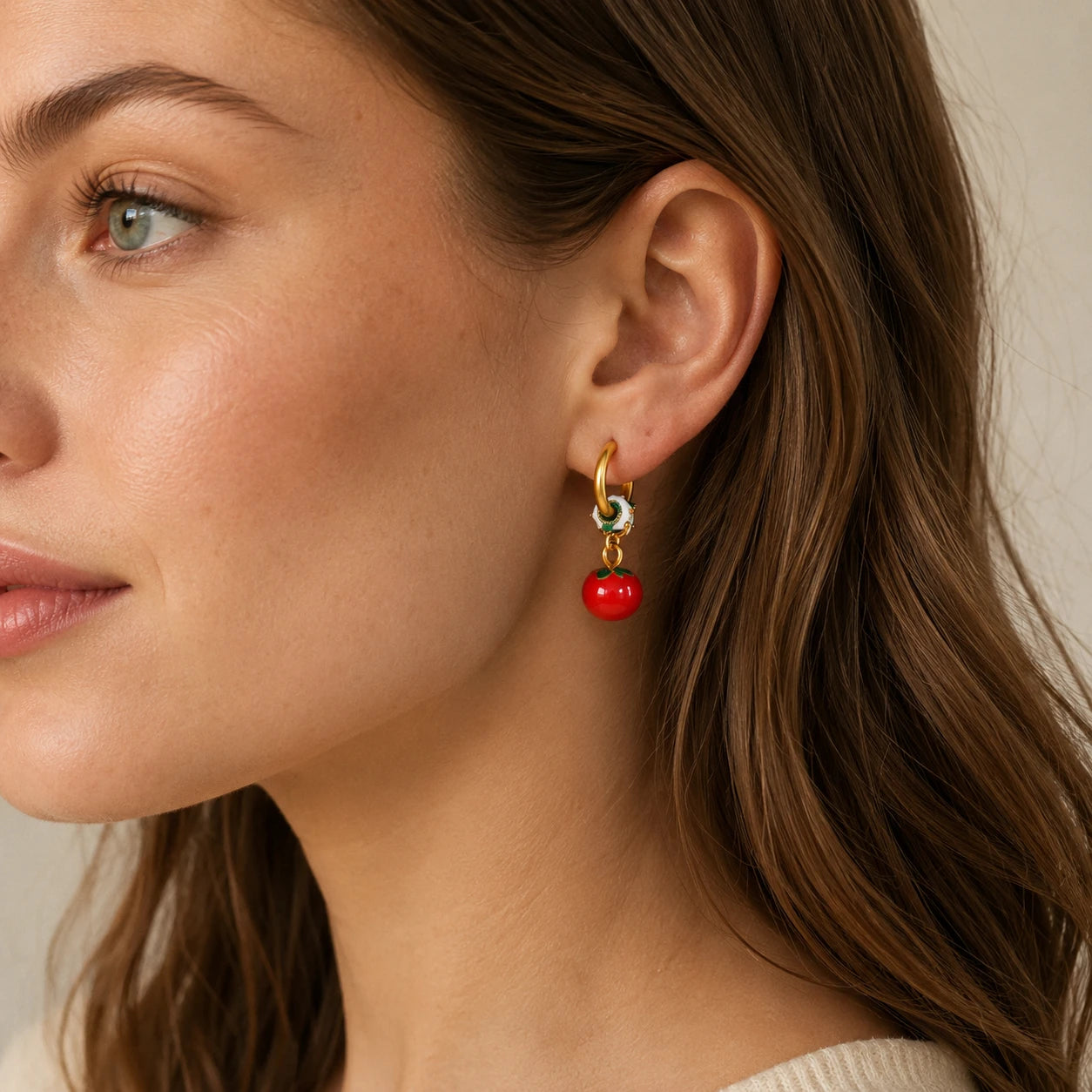 Model wearing red persimmon hoop earrings with a delicate French vintage look