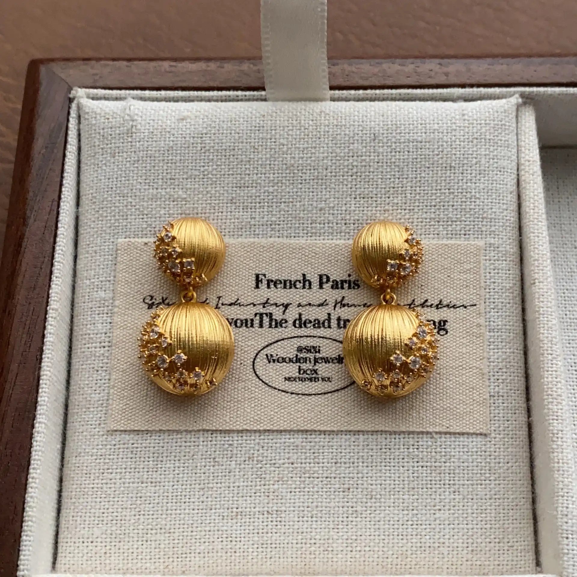 Gold-plated double sphere earrings with a sculptural textured surface